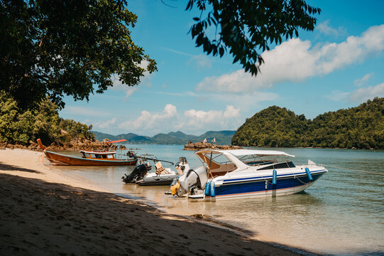 Speedboat and long-tail boats on the beach at Hong Islands, Krabi