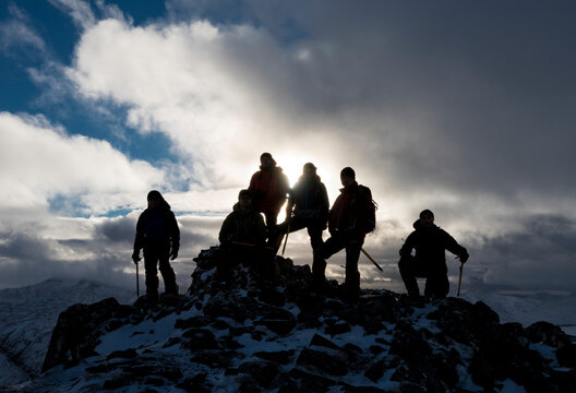 Mountaineers silhouetted on the summit of Buachaille Etive Beag, Glencoe