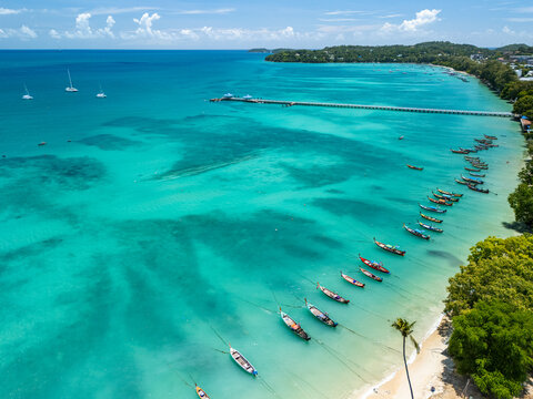 Long-tail boats moored in the turquoise Andaman Sea off Phuket