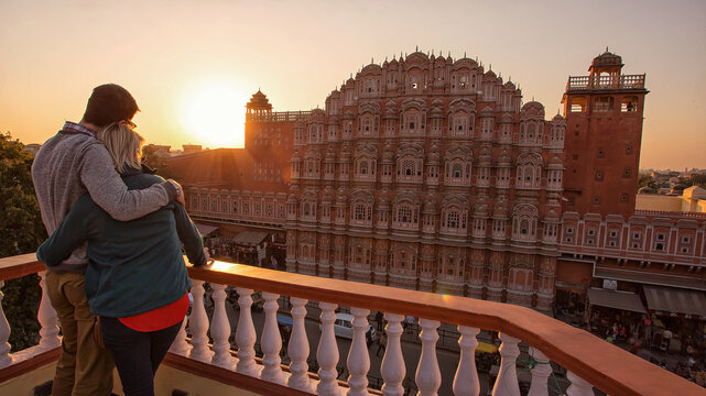 A couple looking out at Hawa Mahal at sunset in Jaipur, Rajasthan