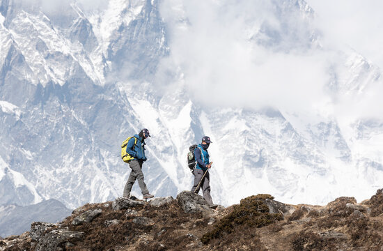 A mountaineer and sherpa walking a ridge in the Khumbu, Everest region
